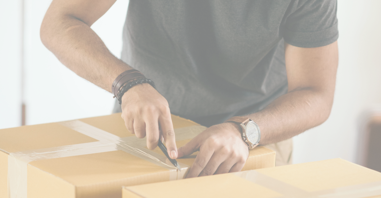 A man handling cardboard boxes