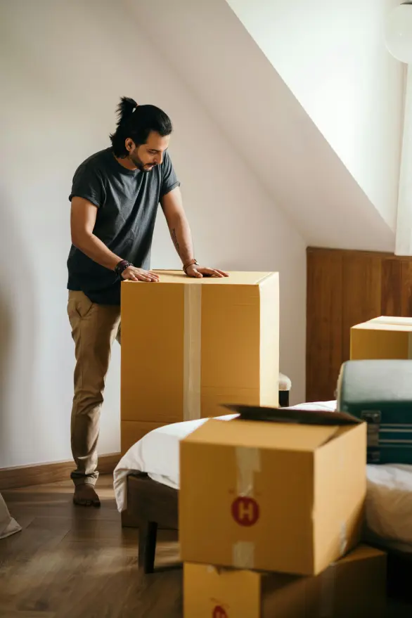 A man packing cardboard boxes