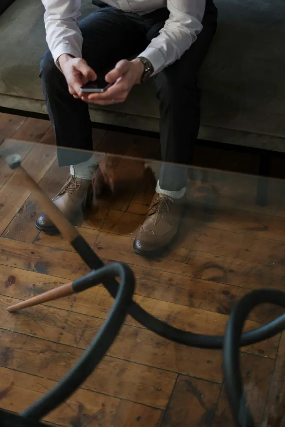 Looking down at a man sitting on a couch in a coaching session