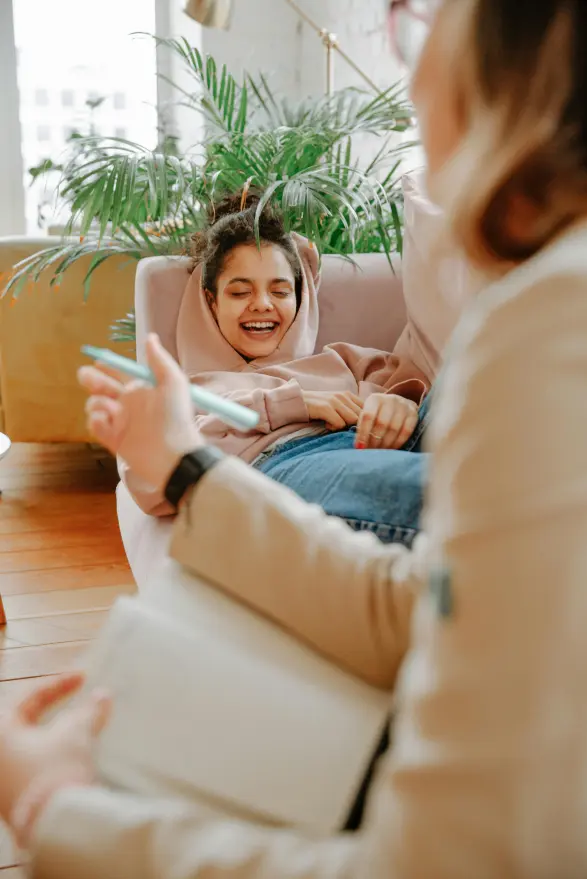A couch and young woman talking and laughing together