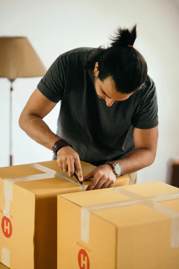 A man carefully handling a cardboard box