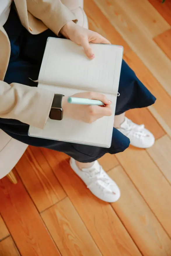 A coach taking notes in a journal
